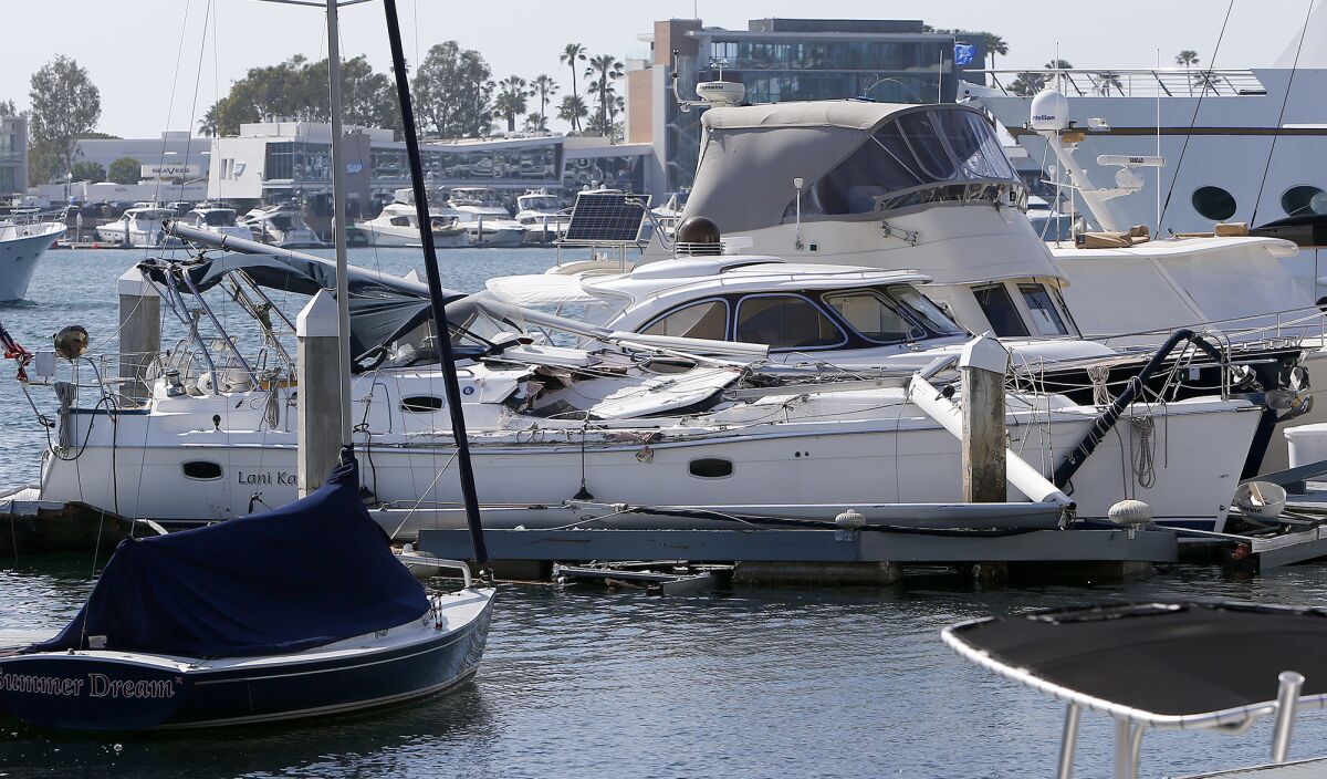 A damaged yacht docked near A'maree's in Newport Harbor in Newport Beach on Thursday.