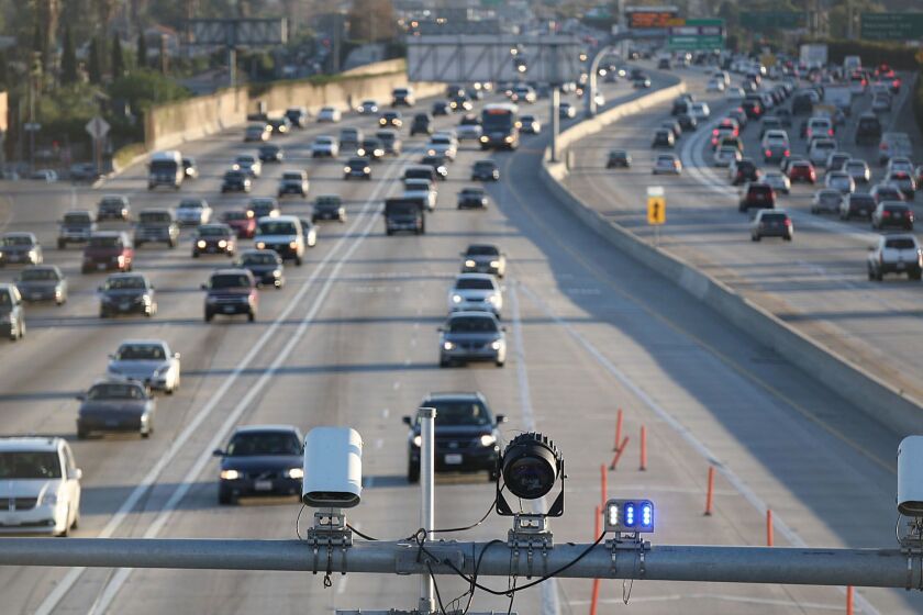 Cameras and electronic sensors stand over the express lane south of the Slauson Avenue transit station on the 110 Freeway.