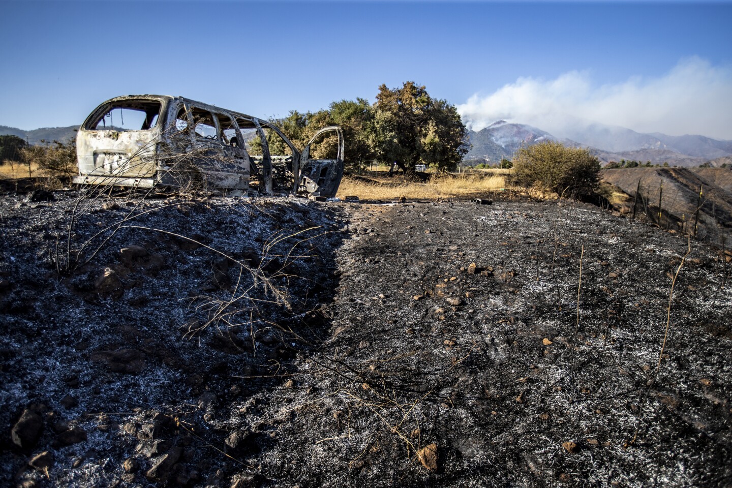 A shell of a burned car sits along Avenida Miravilla days after the Apple fire rushed through.