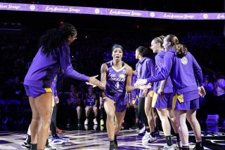 The Sparks' Lexie Brown is cheered by teammates as she is introduced before a preseason game 