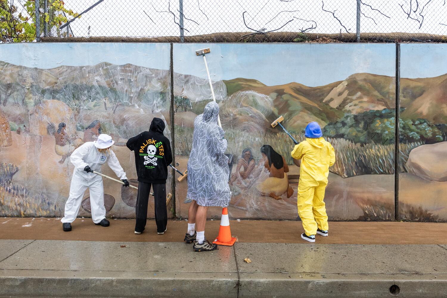 PACIFIC PALISADES, CA - NOVEMBER 15: Volunteers help clean the Temescal Canyon Mural,