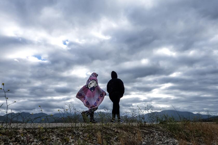 LAKE VIEW TERRACE, CA - APRIL 13: A blanket provides protection from the cold wind at the Hansen Dam bike path on Saturday, April 13, 2024 in Lake View Terrace, CA. Rain is expected for the Southland this weekend. (Myung J. Chun / Los Angeles Times)