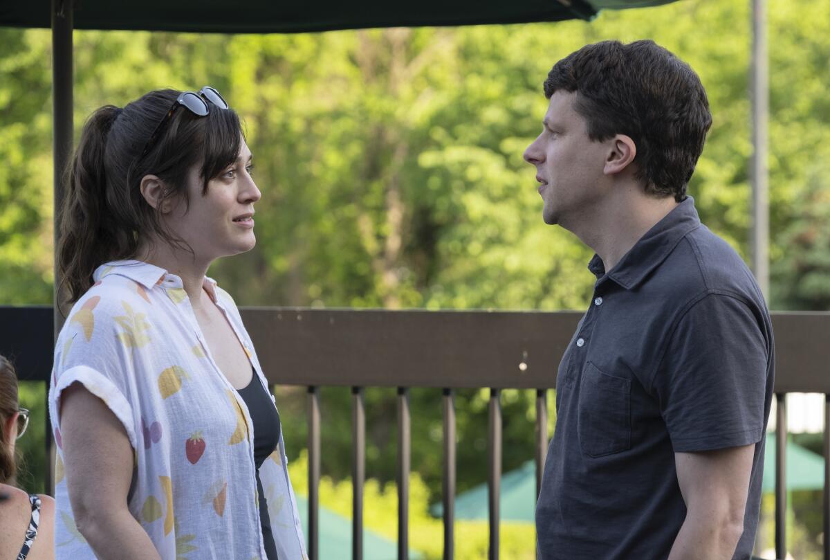 Lizzy Caplan and Jesse Eisenberg stand outside talking in "'Fleishman Is in Trouble."