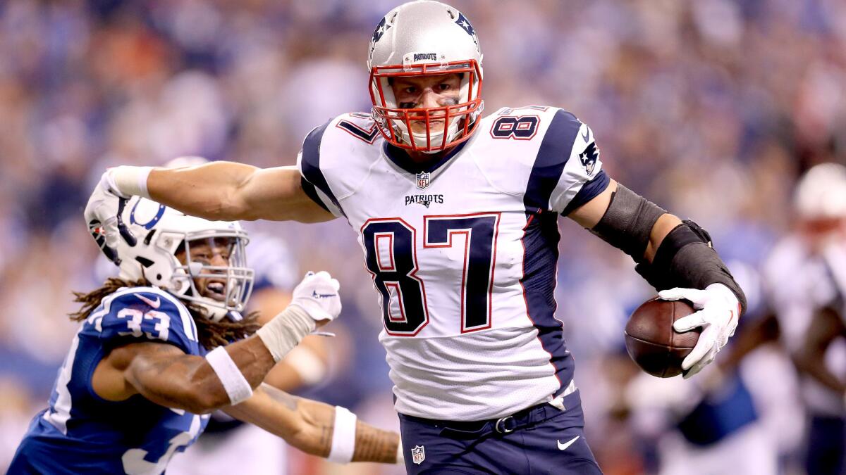 Patriots tight end Rob Gronkowski evades Colts safety Dwight Lowery for a touchdown in the third quarter Sunday.