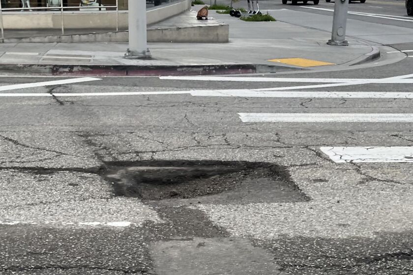 A wide and deep pothole at Western and Sixth St. in Los Angeles on January 12, 2023.