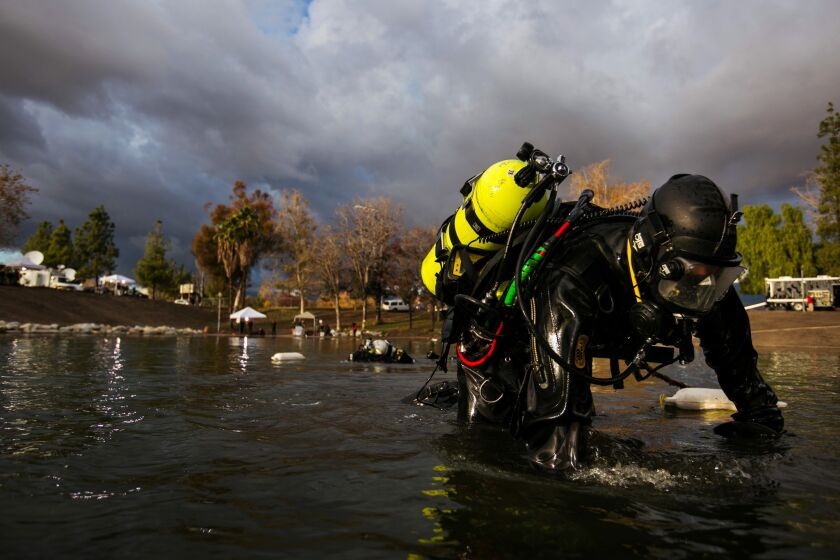 FBI dive team search the bottom of Seccombe Lake for electronic devices or other evidence possibly disposed in the lake as they continue to investigate the terrorist attack in San Bernardino.