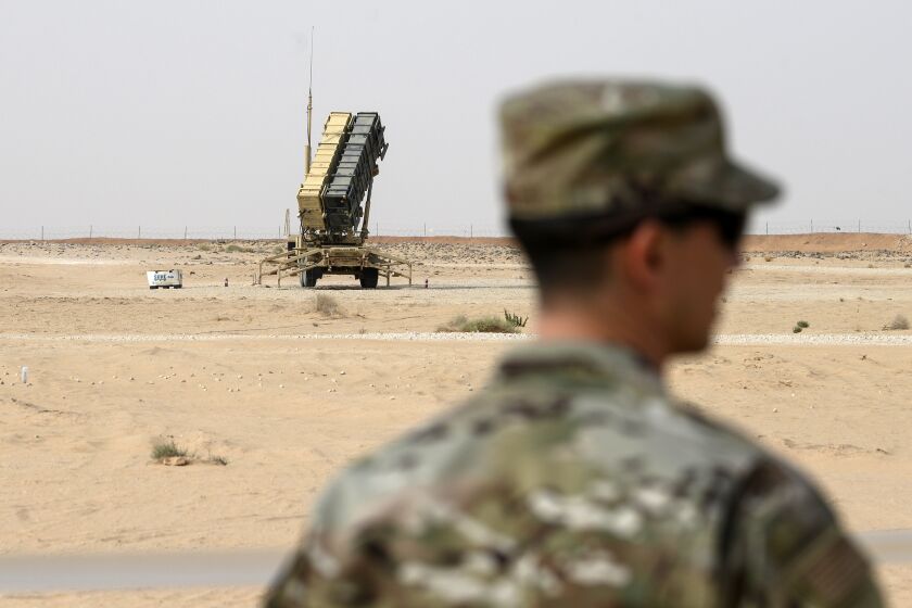 FILE - In this Feb. 20, 2020, file pool photo, a member of the U.S. Air Force stands near a Patriot missile battery at Prince Sultan Air Base in Saudi Arabia. The U.S. has removed its most advanced missile defense system and Patriot batteries from Saudi Arabia's Prince Sultan Air Base in recent weeks, even as the kingdom faced continued air attacks from Yemen's Houthi rebels, satellite photos analyzed by The Associated Press show. (Andrew Caballero-Reynolds/Pool via AP, File)