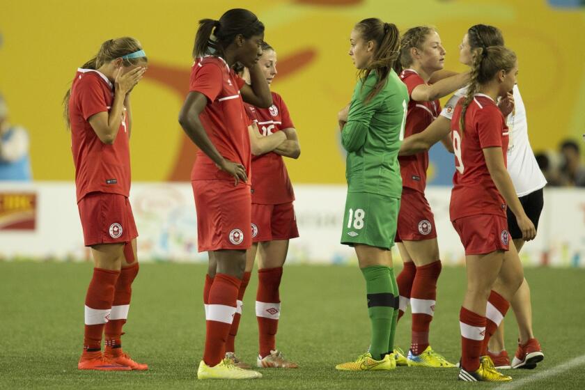 Players of Canada react after losing 1-2 to Mexico in the 2015 Pan Am Games women's bronze medal soccer match in Hamilton, Ontario, Friday, July 24, 2015. (Peter Power/The Canadian Press via AP)