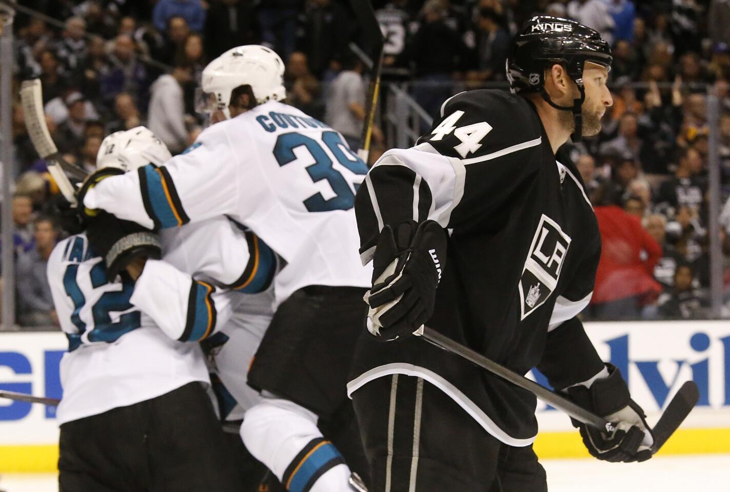 Kings defenseman Robyn Regehr skates back to the bench as the San Jose Sharks celebrate Patrick Marleau's winning goal in overtime of a 4-3 win in Game 3 of the Western Conference quarterfinals at Staples Center.