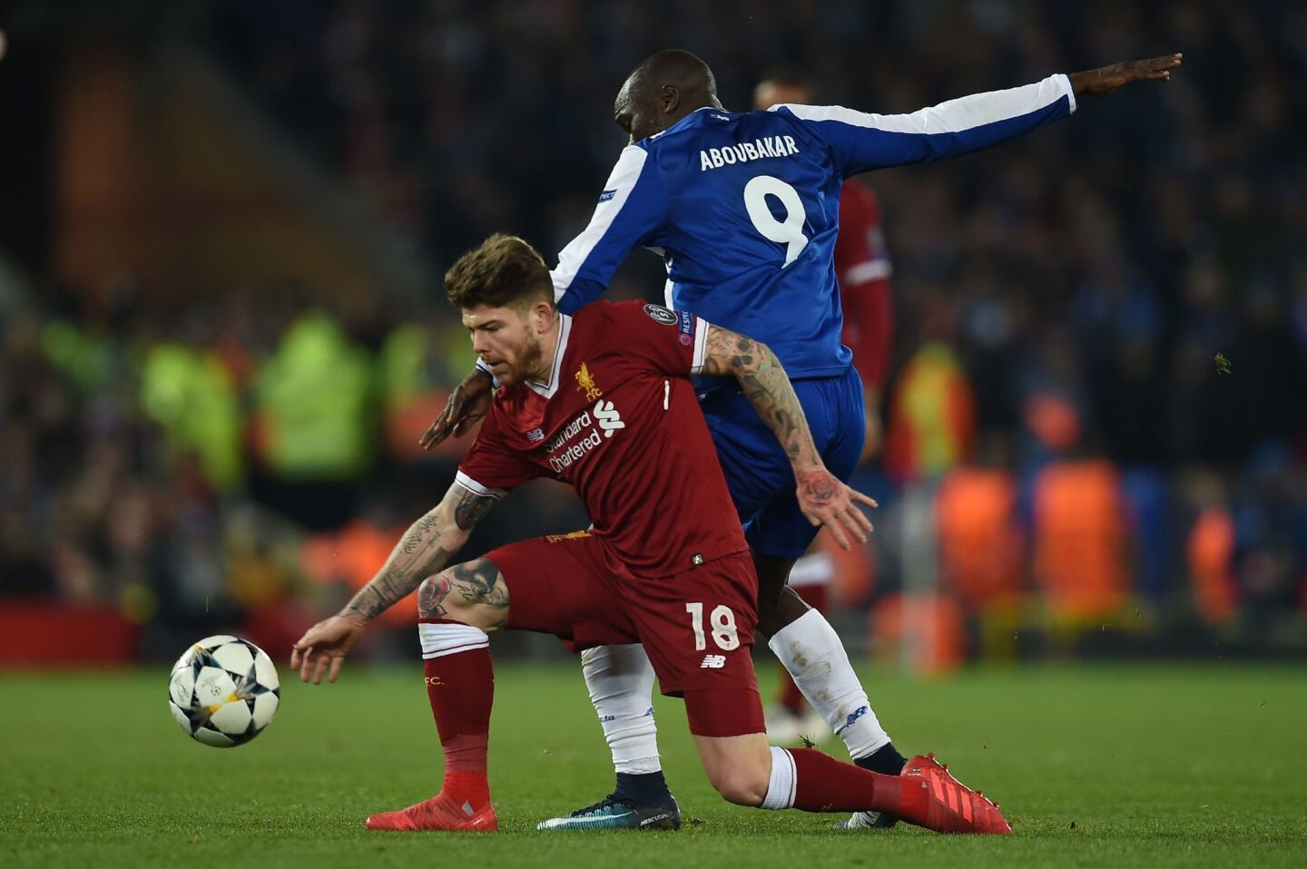 Liverpool's Spanish defender Alberto Moreno (L) vies with Porto's Cameroonian striker Vincent Aboubakar during the UEFA Champions League round of sixteen second leg football match between Liverpool and FC Porto at Anfield in Liverpool, north-west England on March 6, 2018. / AFP PHOTO / PAUL ELLISPAUL ELLIS/AFP/Getty Images ** OUTS - ELSENT, FPG, CM - OUTS * NM, PH, VA if sourced by CT, LA or MoD **