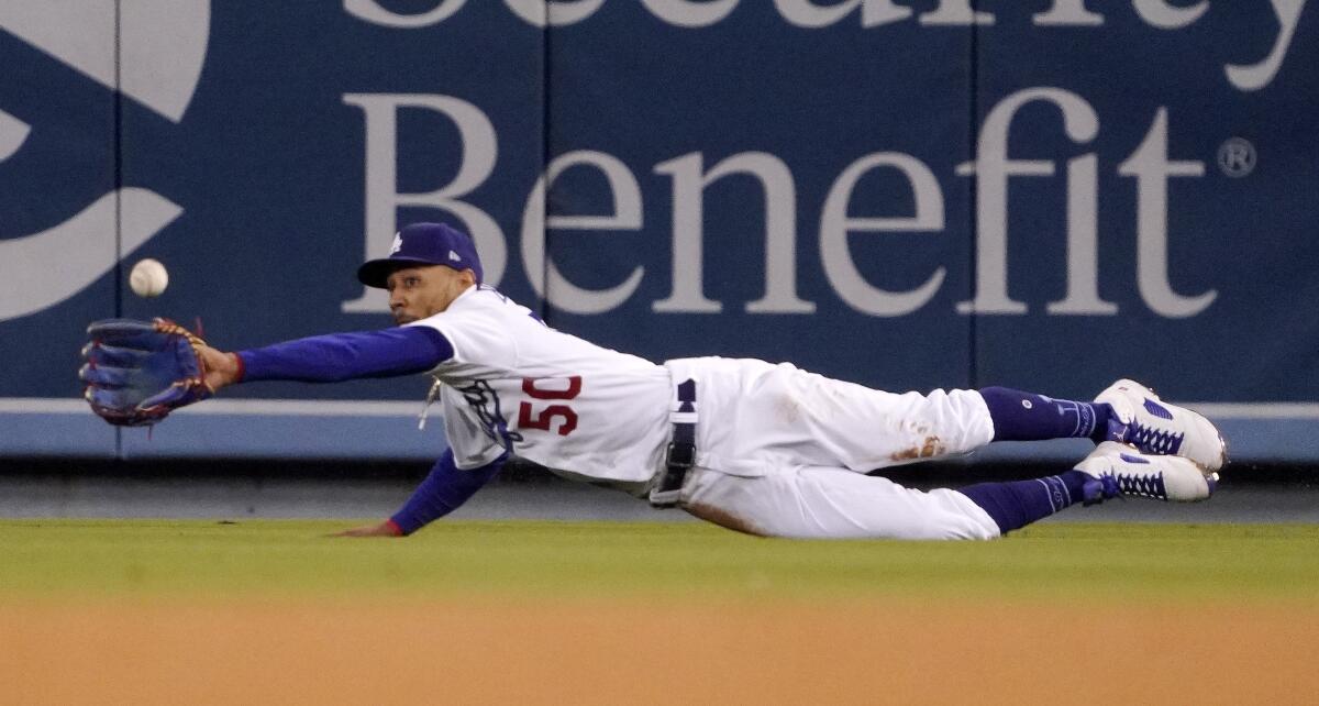 Dodgers right fielder Mookie Betts dives to make a catch on a ball in right field.