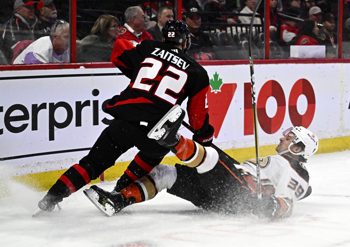 Anaheim Ducks center Sam Carrick falls after clashing with Ottawa Senators defenseman Nikita Zaitsev.