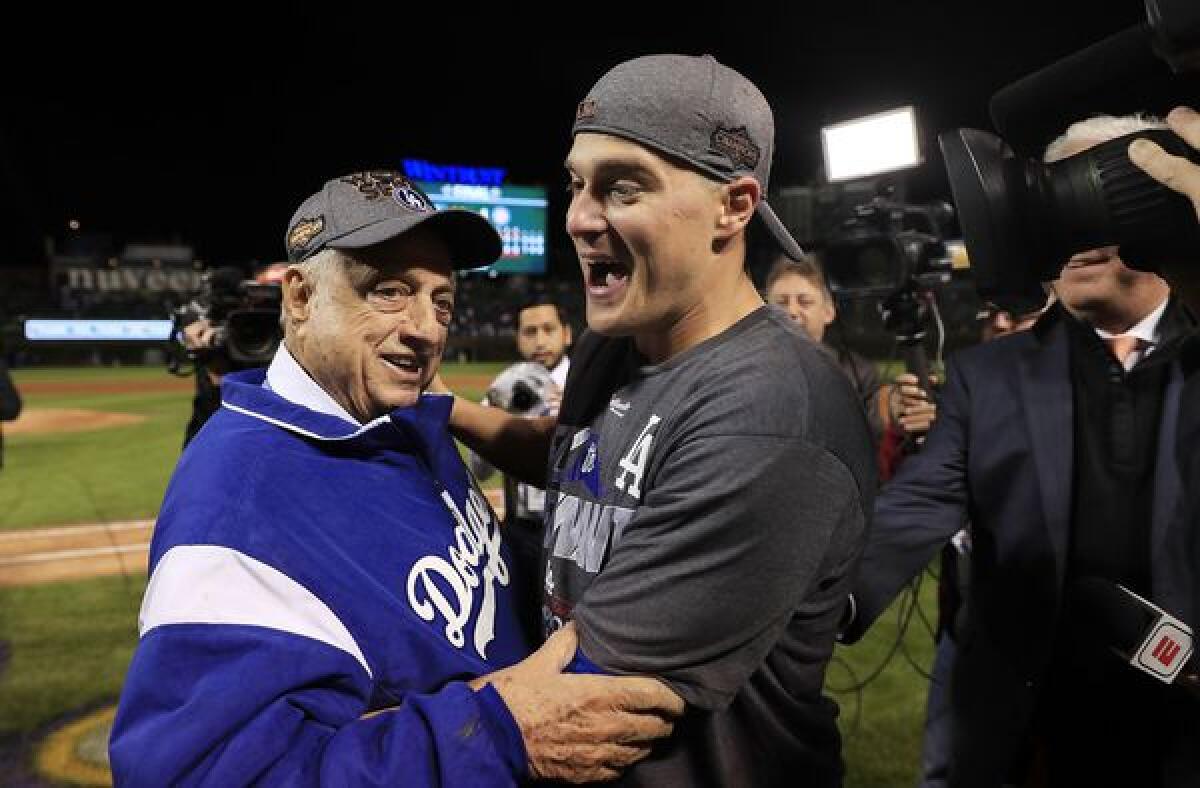 Former Dodgers manager Tommy Lasorda congratulates Enrique Hernandez after the utility man hit three home runs during Game 5 of the National League Championship Series.