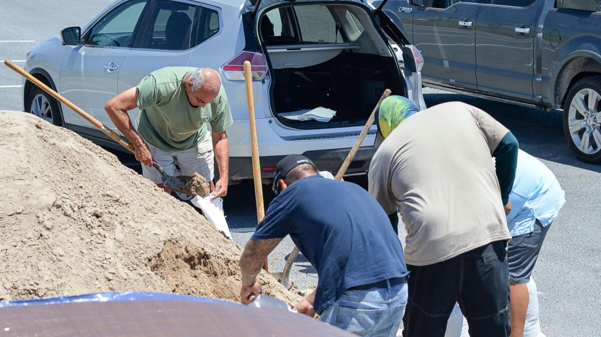 Residents of South Padre Island, Texas, fill sandbags in preparation for Harvey.