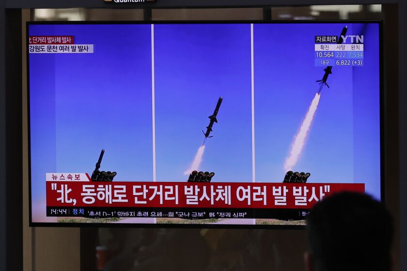 People watch a TV screen airing reports about North Korea's firing missiles with file images of missiles at the Seoul Railway Station in Seoul, South Korea, Tuesday, April 14, 2020. South Korea says North Korean fighter jets have fired missiles off the North's east coast. A South Korean defense official says the North launched several fighter jets after it conducted suspected cruise missile tests on Tuesday morning. The letters read "North, fired several short-range projectiles." (AP Photo/Lee Jin-man)
