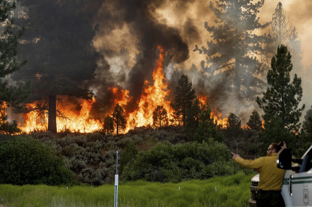 Firefighter Kyle Jacobson watches over Sugar's fire