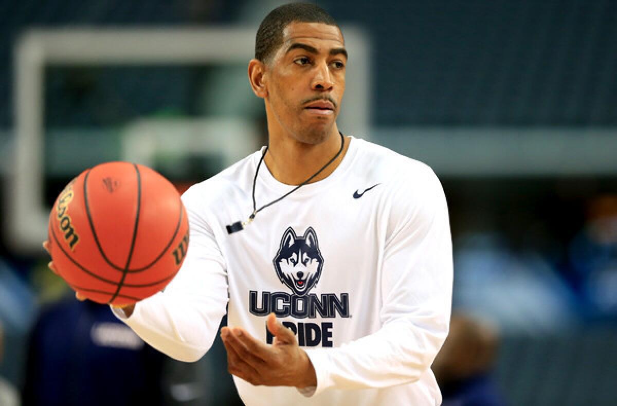 Connecticut Coach Kevin Ollie takes the Huskies through a practice in preparation for the Final Four.