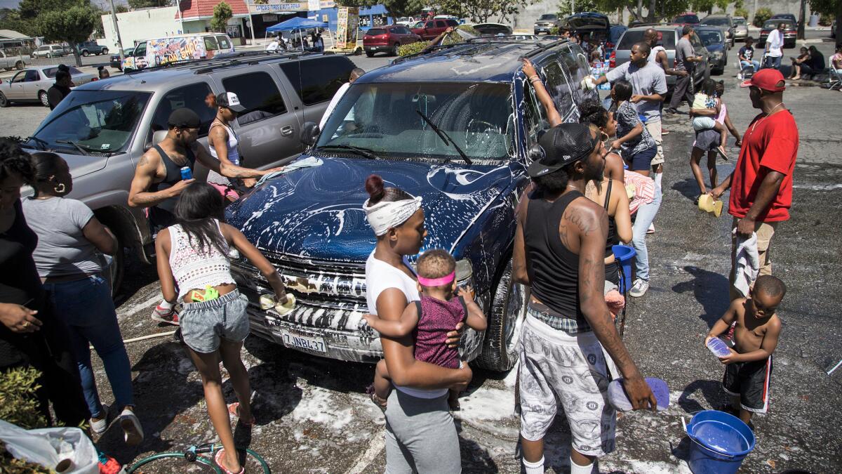 Hundreds of family and friends participate in a car wash to benefit the family of Travon Williams, 9, who was shot and killed outside Superior Liquor Store on July 8 in San Bernardino.