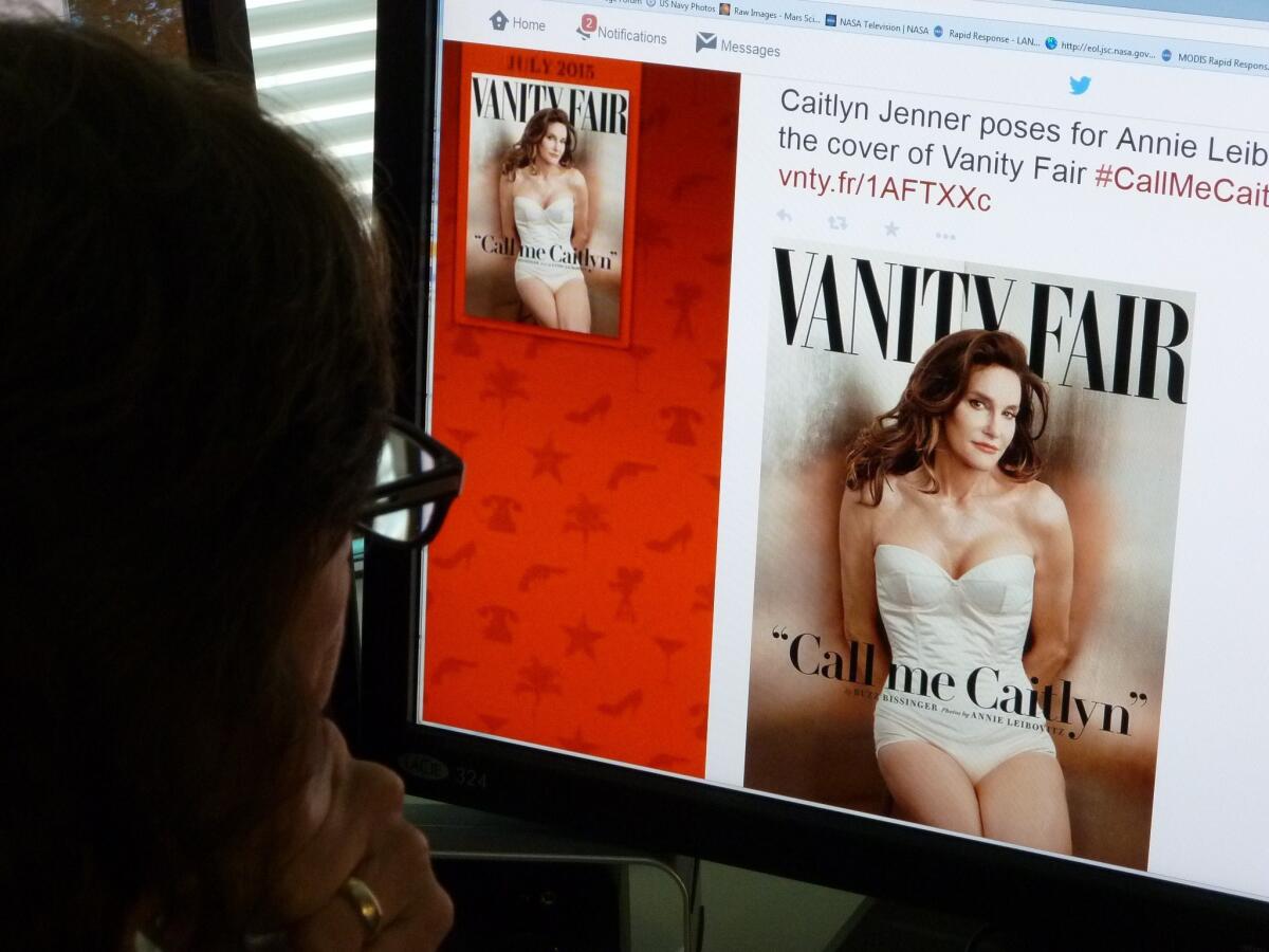 A journalist looks at Vanity Fair's Twitter site about Caitlyn Jenner, who will be featured on the July cover of the magazine.