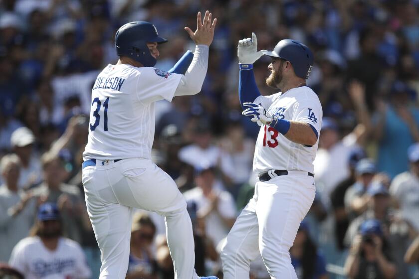 Los Angeles Dodgers' Max Muncy, right, celebrates his two-run home run with Joc Pederson.