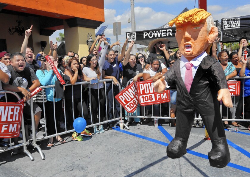 Onlookers yell at a Donald Trump piñata during a "Take It Out on Trump" event in Montebello last September.