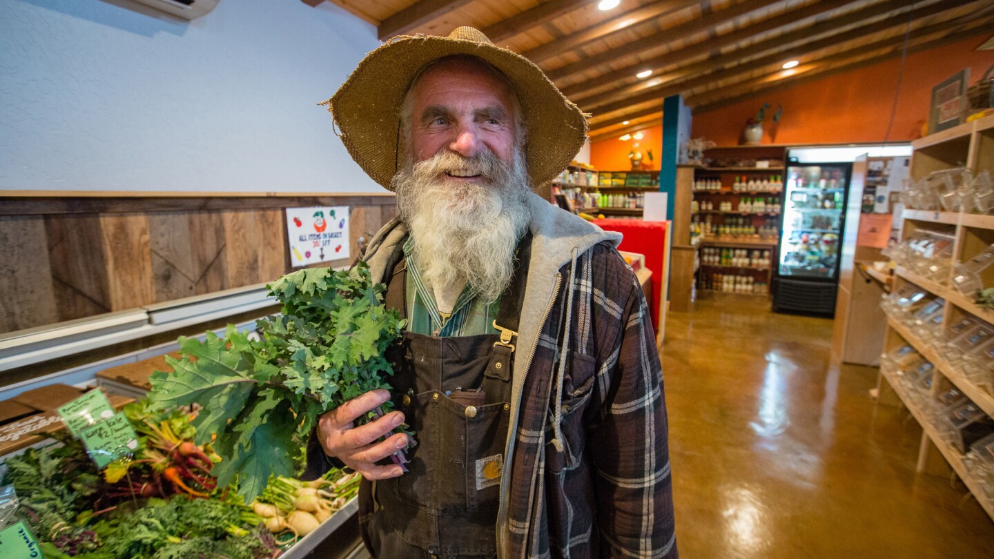 Farmer Hansel Kern, 60, stands in the Gnarly Carrot, the organic store he operates in North Fork, Calif.