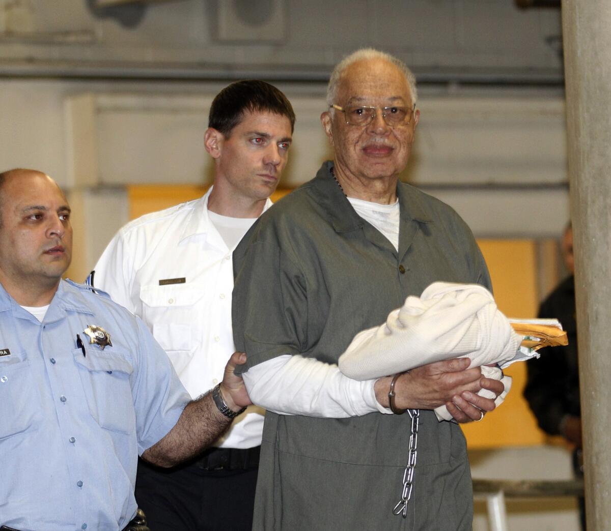 Dr. Kermit Gosnell is escorted to a waiting police van upon leaving the Criminal Justice Center in Philadelphia.