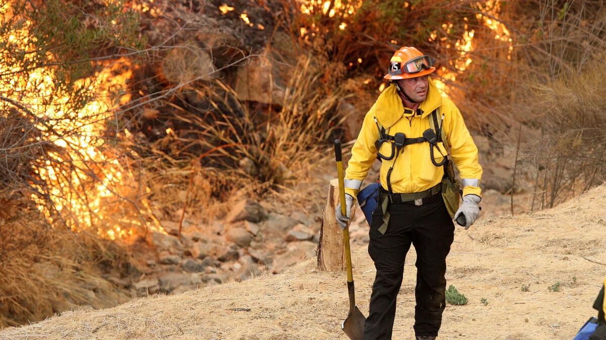 A Los Angeles fireman on La Tuna Canyon Road on Friday. The La Tuna fire placed about 400 Glendale residents under a mandatory evacuation order.