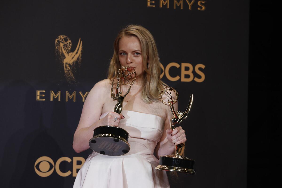 Elisabeth Moss of "The Handmaid's Tale" with her Emmys for drama series and actress in a drama series.