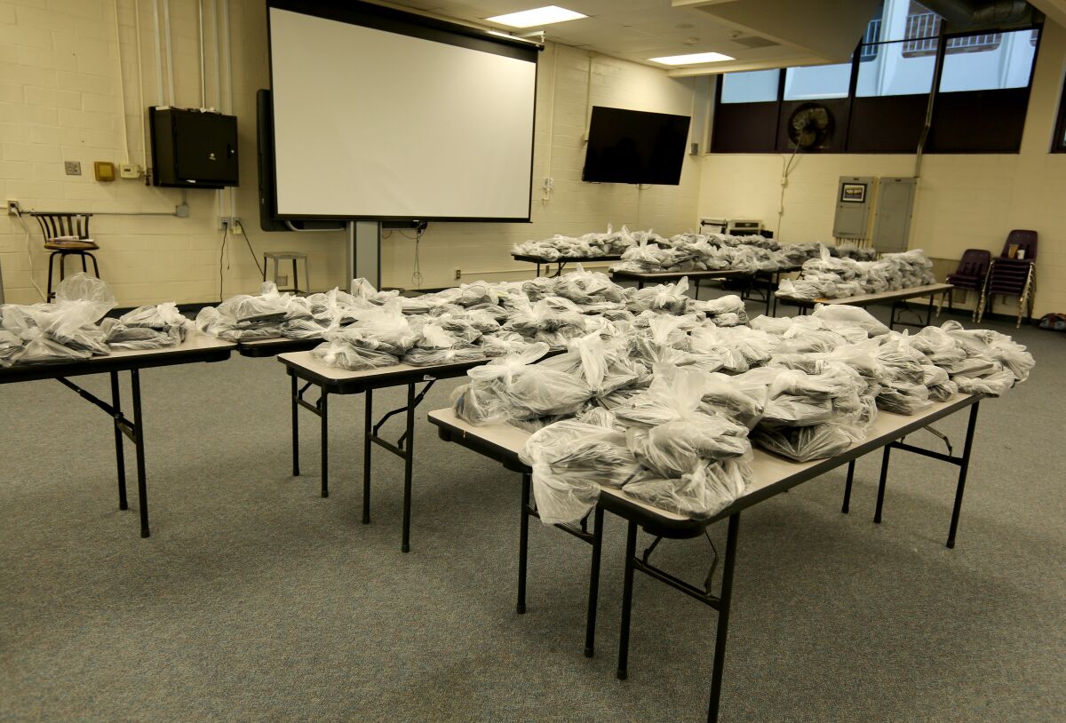 Hundreds of loaner laptops were ready for pickup during the Glendale Unified School District distribution of more than 5,000 Chromebooks to students who need technology at home for remote learning, at Hoover High School.