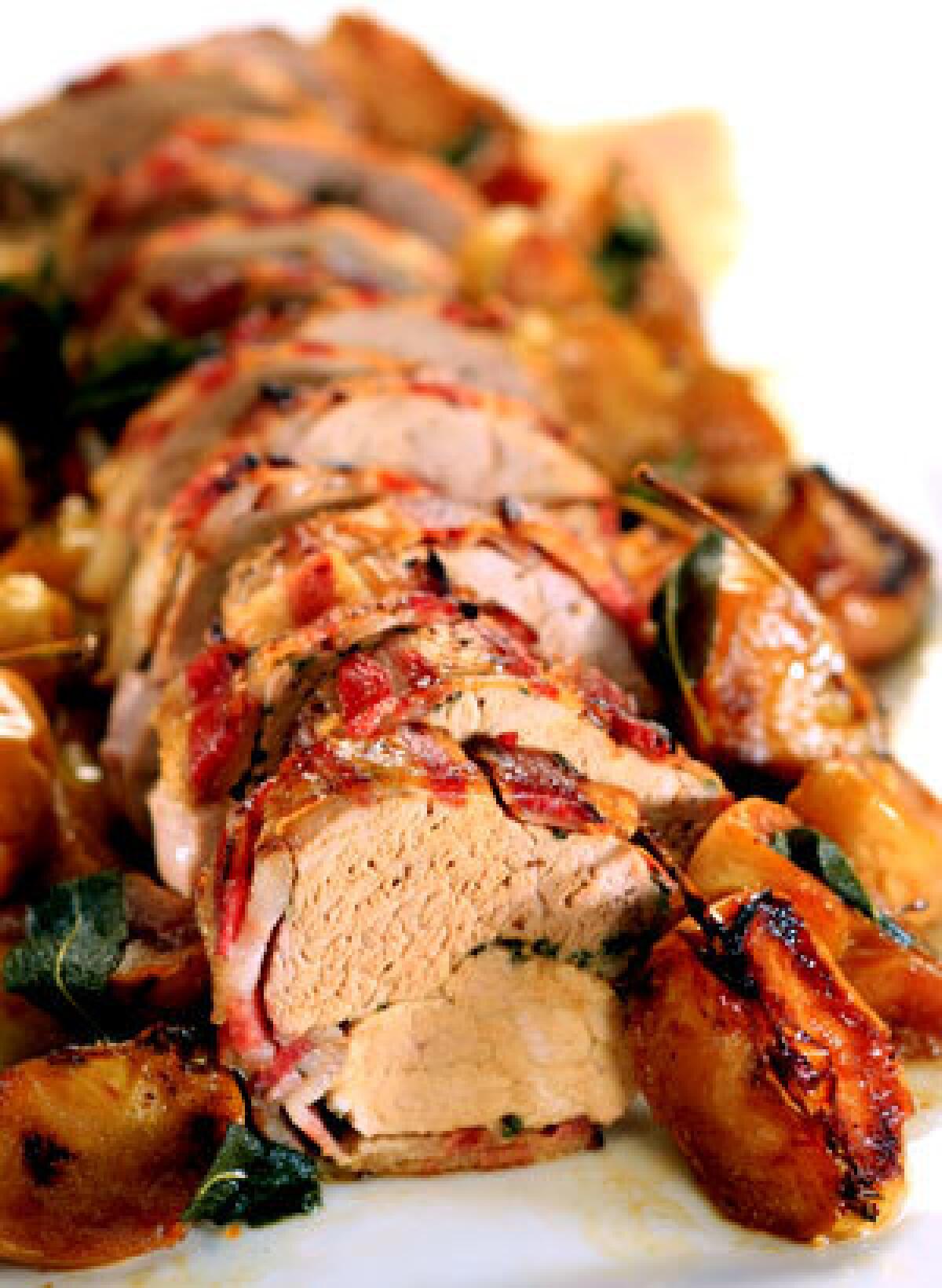 IT'S A WRAP: Bacon-wrapped pork loin with roasted apples.