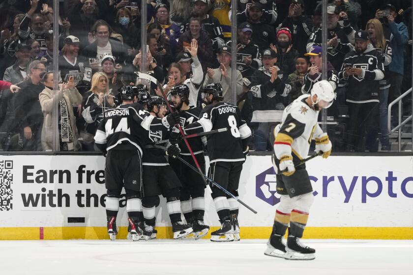 Los Angeles Kings celebrate a goal by Alex Iafallo as Vegas Golden Knights' Alex Pietrangelo (7) skates past during the third period of an NHL hockey game Tuesday, Dec. 27, 2022, in Los Angeles. The Kings won 4-2. (AP Photo/Jae C. Hong)