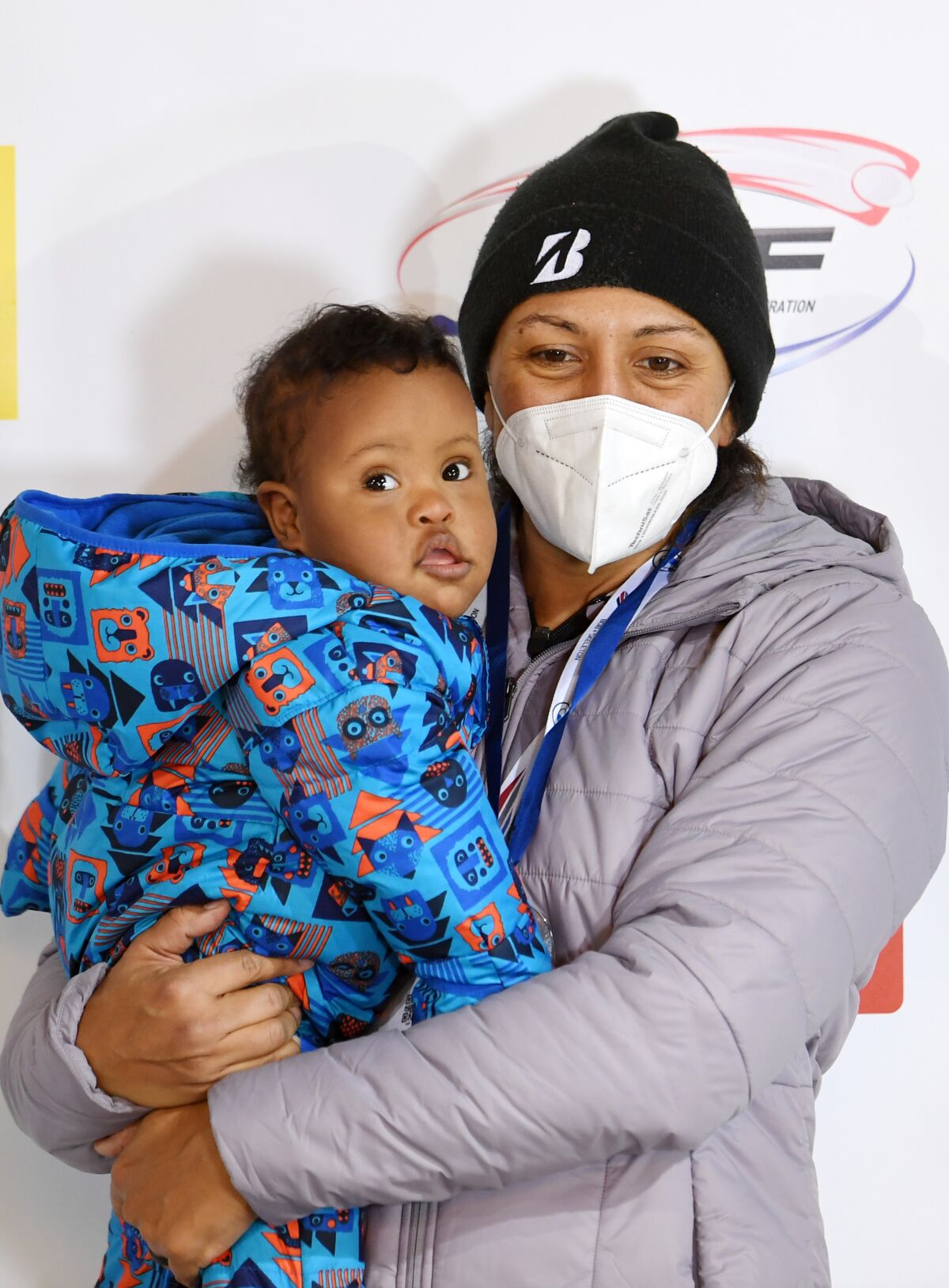 U.S. bobsled pilot Elana Meyers Taylor holds her son, Nico, during an award ceremony Jan. 23, 2021.