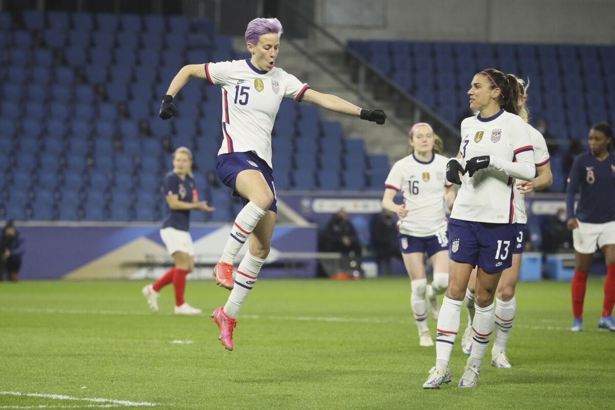 United States' Megan Rapinoe (15) leaps into the air after scoring on a penalty kick 