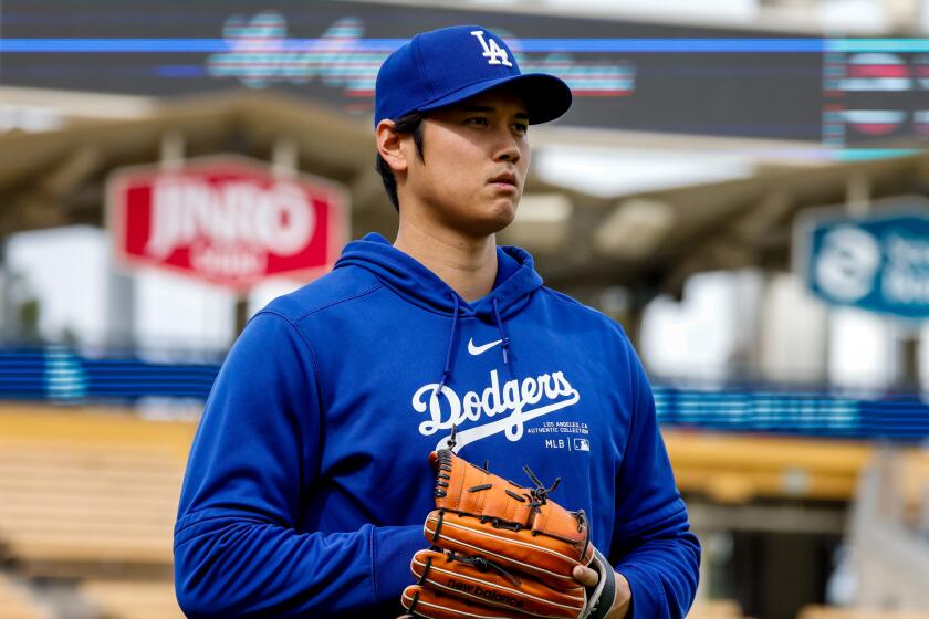 Los Angeles, CA - March 25: Shohei Ohtani does some pitching practice after he addreses allegations.