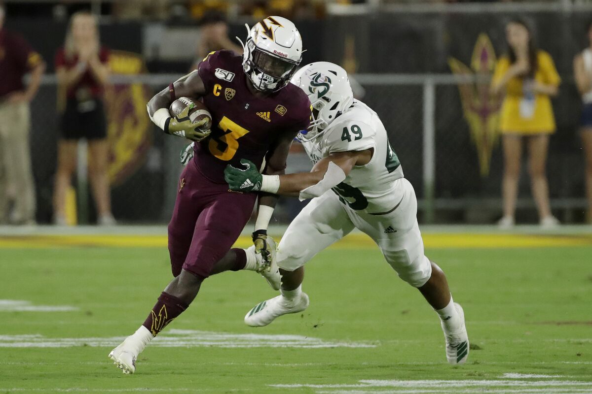 Arizona State running back Eno Benjamin (3) tries to get away from Sacramento State linebacker Armon Bailey (49) during the second half on Friday in Tempe, Ariz.
