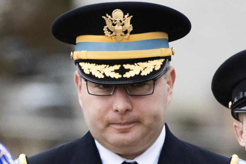 Army Lieutenant Colonel Alexander Vindman, a military officer at the National Security Council, center, arrives on Capitol Hill in Washington, Tuesday, Oct. 29, 2019, to appear before a House Committee on Foreign Affairs, Permanent Select Committee on Intelligence, and Committee on Oversight and Reform joint interview with the transcript to be part of the impeachment inquiry into President Donald Trump. (AP Photo/Manuel Balce Ceneta)