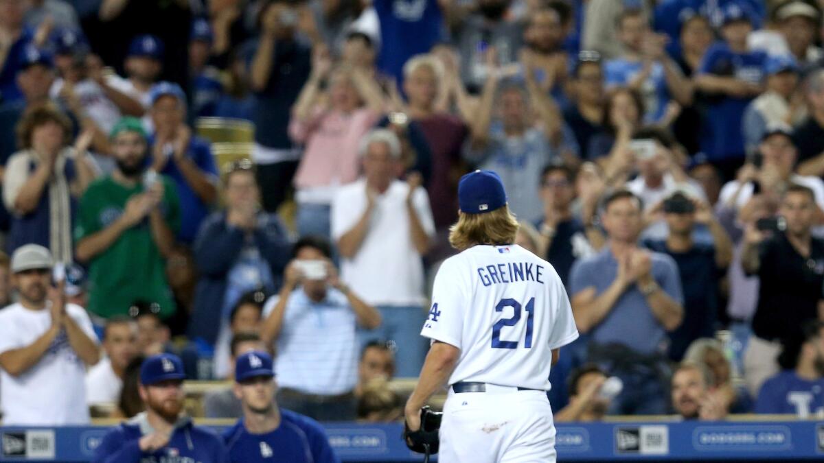 Dodgers starter Zack Greinke receives an ovation from the crowd as he leaves the game against the Pirates in the eighth inning Friday night.