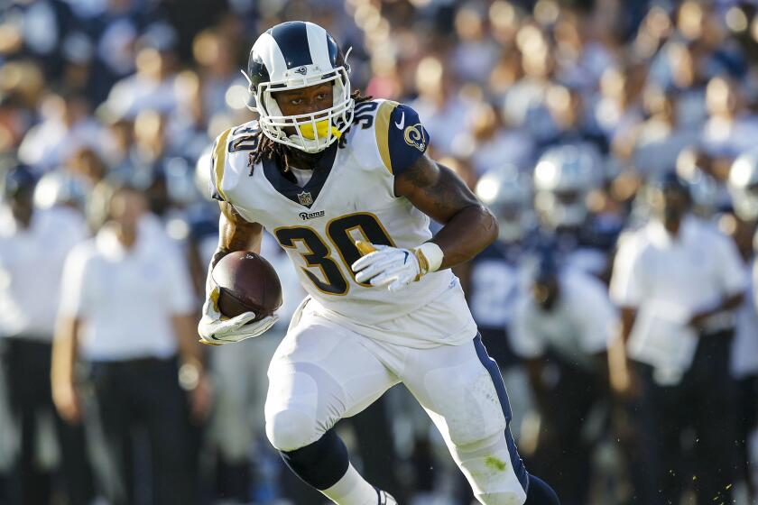 Rams running back Todd Gurley carries the ball during the first quarter of a preseason game against the Cowboys at the Coliseum.