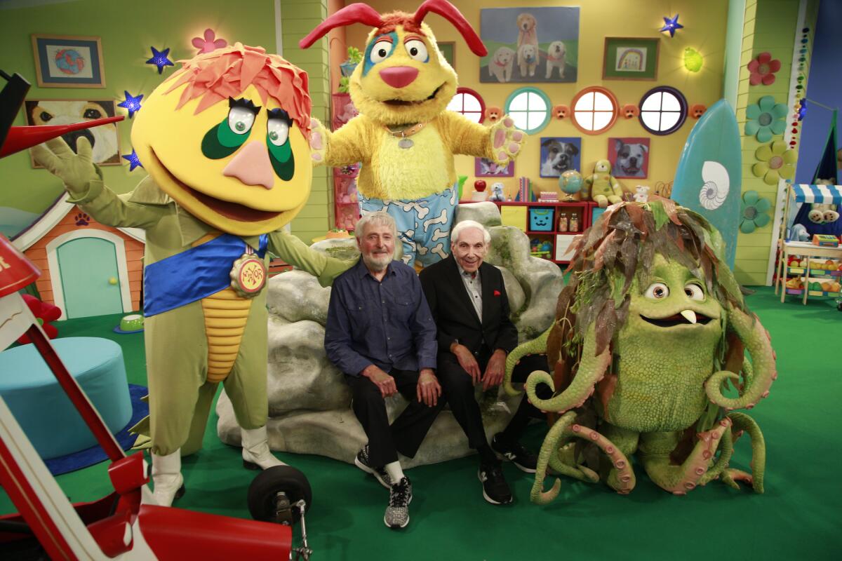 Sid, left, and Marty Krofft sit surrounded by some of their TV creations on the set of "Mutt & Stuff."