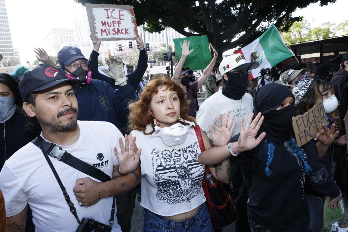 Anti-ICE protesters face off with the LAPD on Temple St. on Monday.