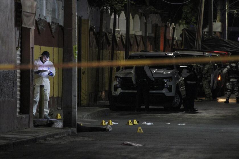 EDITORS NOTE: Graphic content / Forensic personnel work near the body of Gisela Gaytan, candidate for mayor of Celaya for the National Regeneration Movement party (MORENA), after she was gunned down during a campaign rally in San Miguel Octopan, Celaya, Guanajuato state, Mexico on April 1, 2024. A mayoral candidate in the central Mexican state of Guanajuato was murdered on April 1, 2024, amid a wave of violence against local politicians during the election season. She was Gisela Gaytan, who was seeking the mayoralty of Celaya for the Morena party, confirmed Alma Alcaraz, a candidate for the same party to govern Guanajuato. (Photo by Oscar Ortega / AFP)