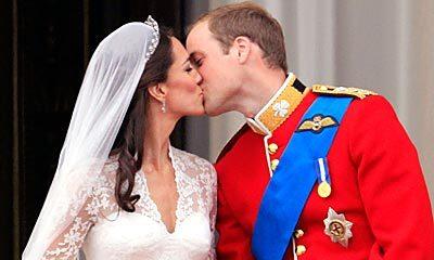 Britain's Prince William kisses his wife Kate, Duchess of Cambridge, on the balcony of Buckingham Palace.