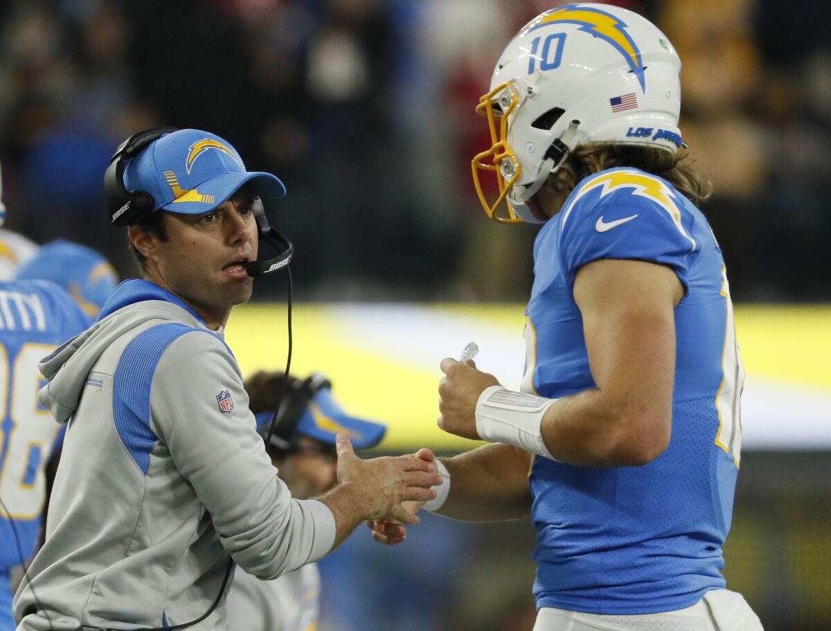 Chargers coach Brandon Staley congratulates quarterback Justin Herbert after a touchdown drive against the Chiefs.
