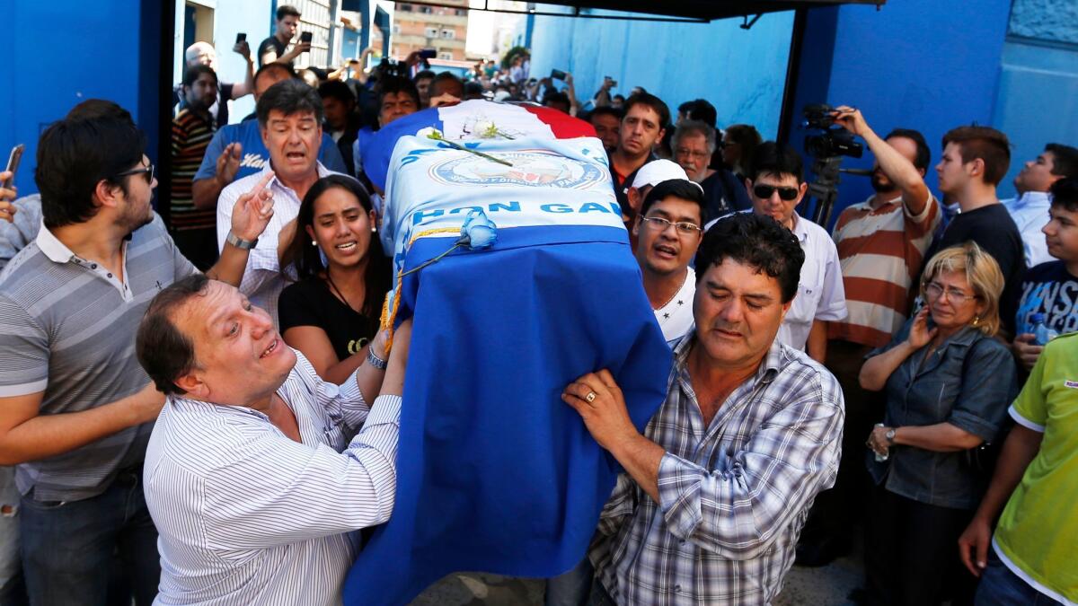 Relatives carry the coffin of Rodrigo Quintana, a member of the Authentic Radical Liberal Party, who was killed Friday in an incident at the party's headquarters, in Asuncion, Paraguay, on April 1, 2017.