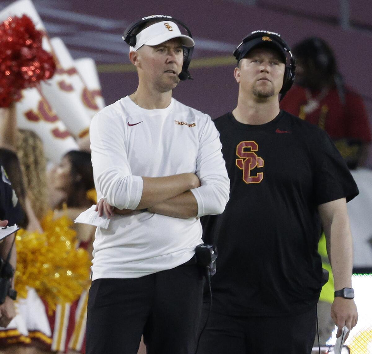 USC coach Lincoln Riley is surrounded by staff on the sideline as he watches his team beat San Jose State 