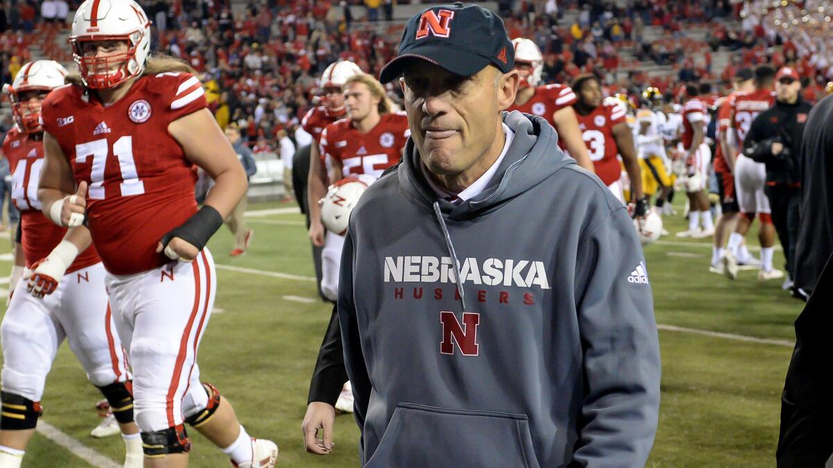 Mike Riley exits the field after Nebraska closed the season with a lopsided loss at home to Iowa on Friday.