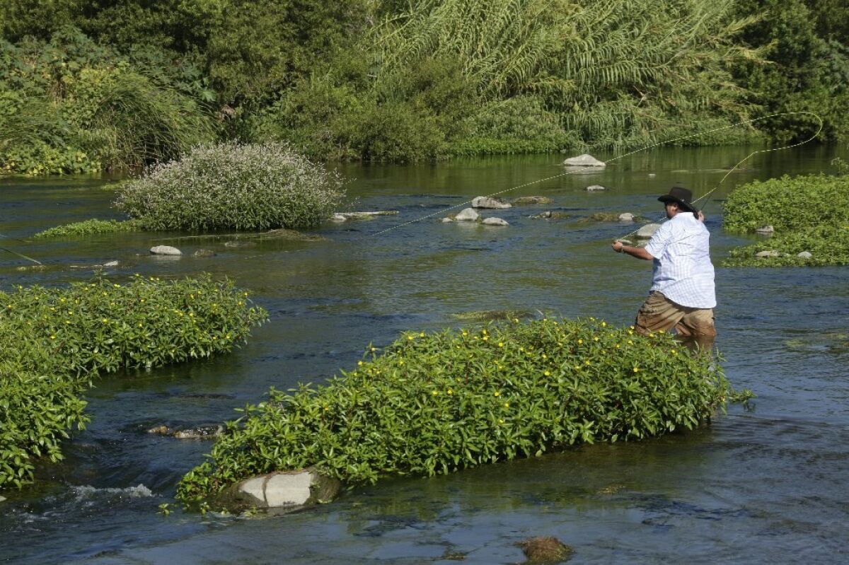Roland Trevino casts a line along a stretch of the Los Angeles River during the first "Off tha' Hook" fishing derby on the urban waterway in 2014.
