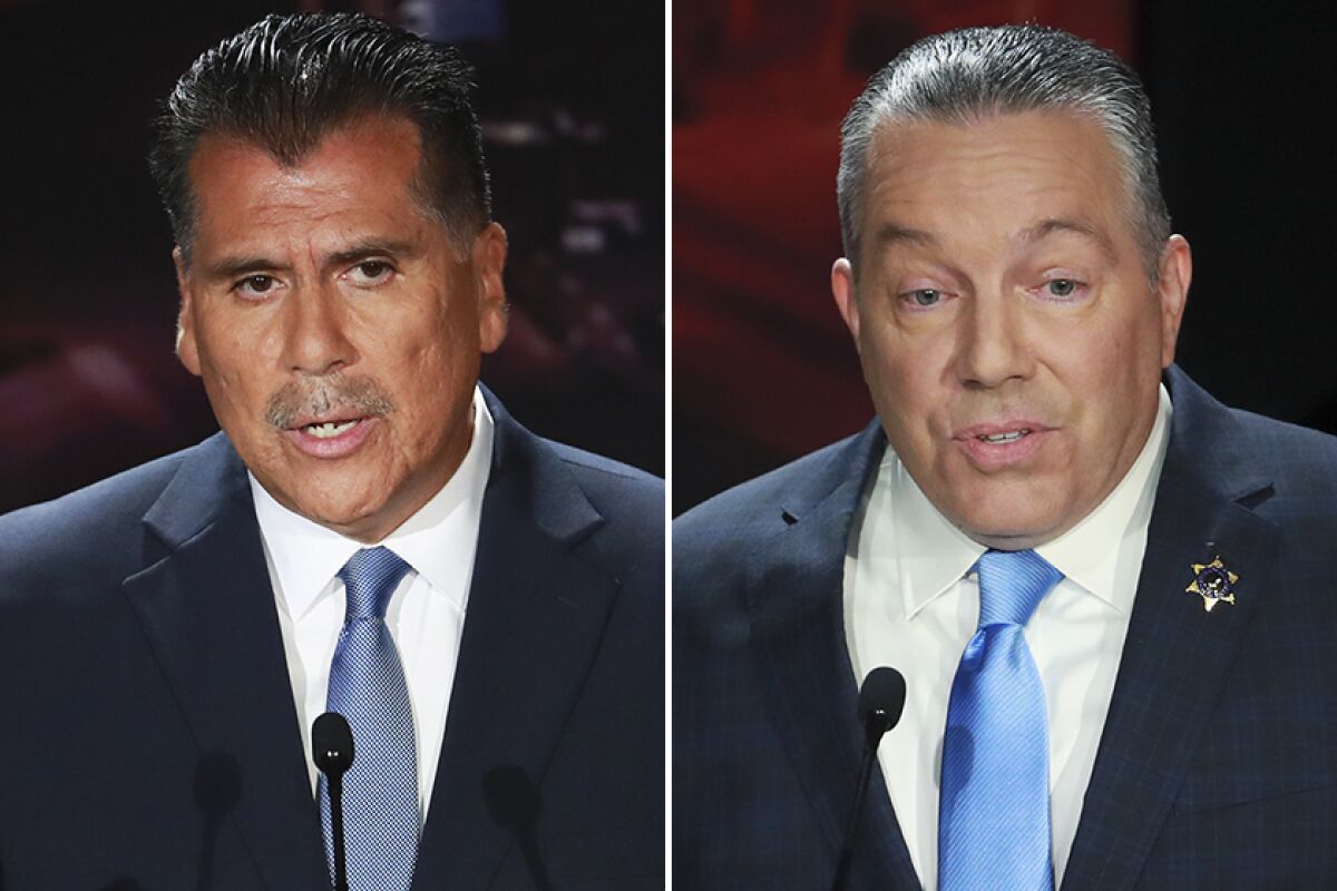 Retired Long Beach Police Chief Robert Luna, left, and Los Angeles County Sheriff Alex Villanueva during a recent debate.