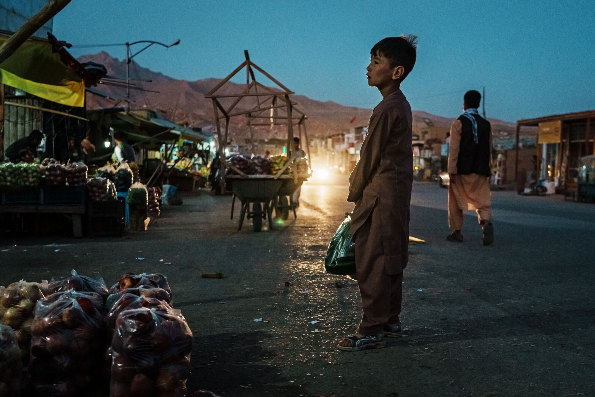  Afghans go about their evening on the main thoroughfare.   